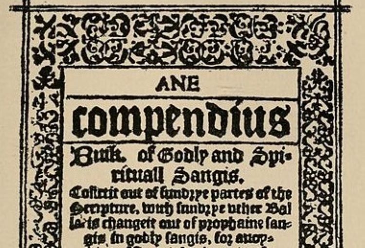 Title page of the Gude and Godlie Ballatis edition of 1600 with blackletter font type and ornamental foliage framing this