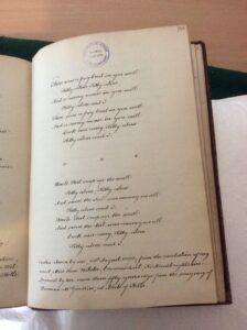 Picture of a manuscript written in a 19th century neat hand, with the lyric of a song and notes about provenance.