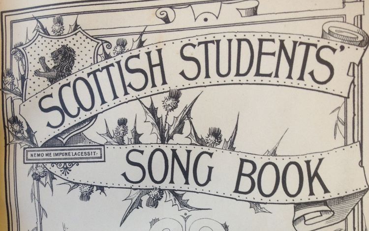 Front of book title Scottish Students Song Book with shield showing lion, and many thistles